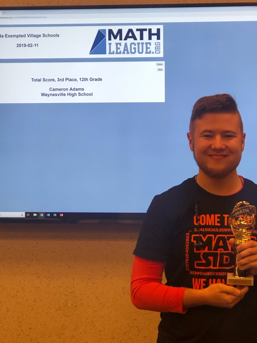 boy holding a trophy